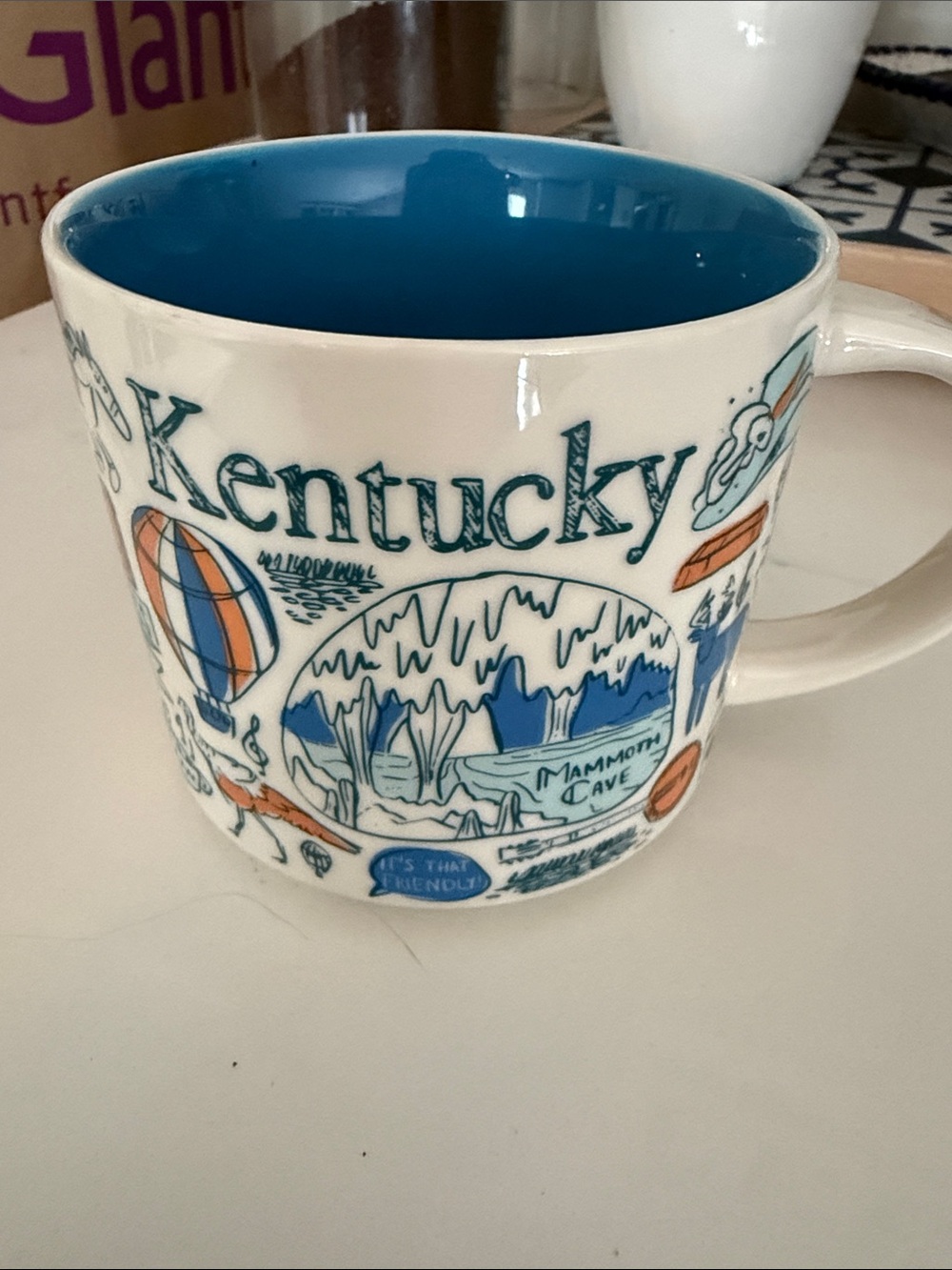 Starbucks Cream Mug with Blue Interior and Orange Accents